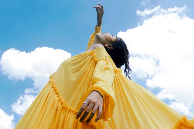 Woman reaching for the sky.